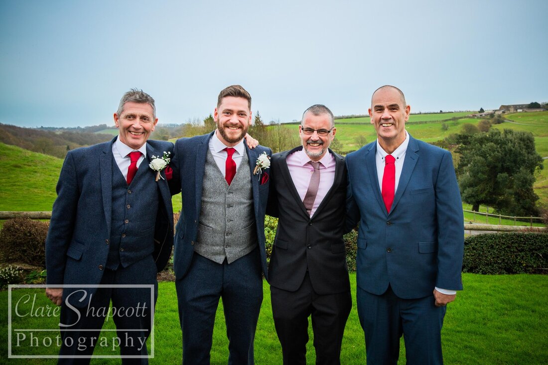 Formal outdoor wedding photograph of groom and best men