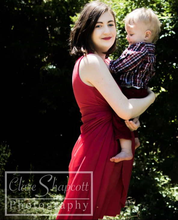 Picture of mother and son in garden with red dress