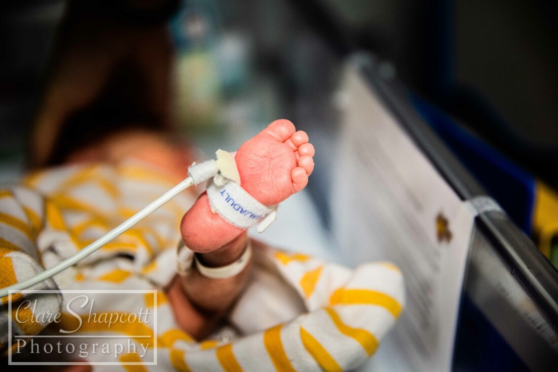 Photoshoot of NICU baby with foot and tag