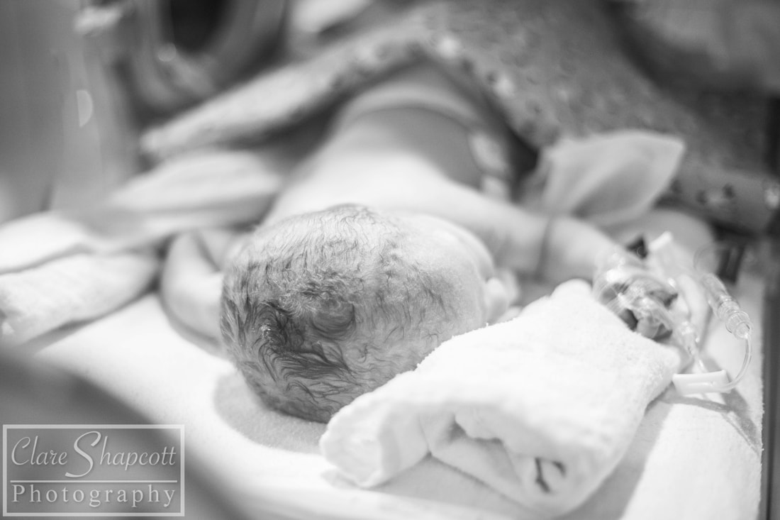 Black and White image of NICU baby laying on blanket