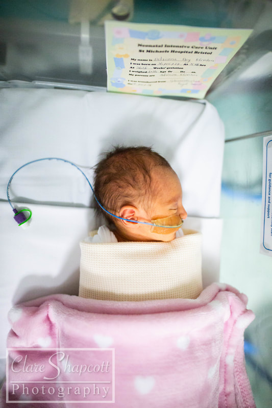 Image of premature child with feeding tube and blankets
