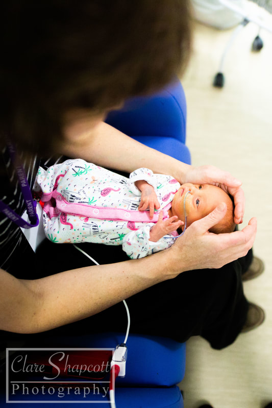 Photograph of mother holding newborn baby girl in Southmead Hospital's Neonatal Unit.