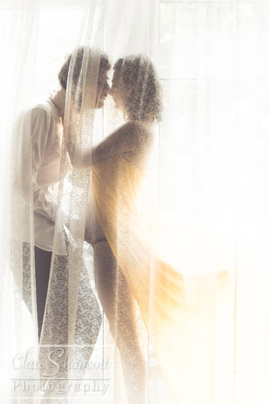 Couple pregnancy photograph behind curtains
